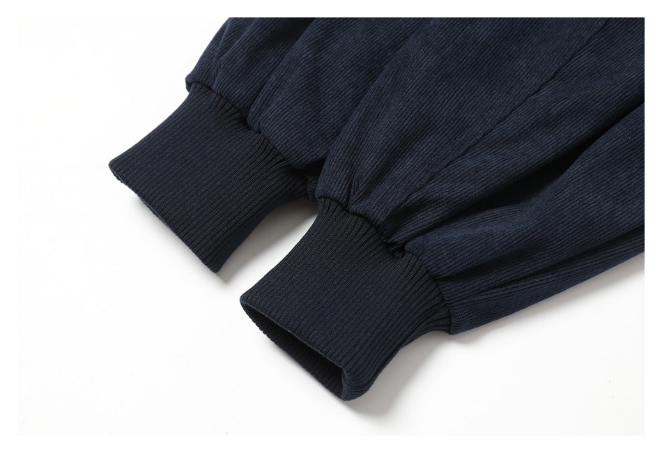 Close-up of two ribbed cuffs on dark navy sleeves.