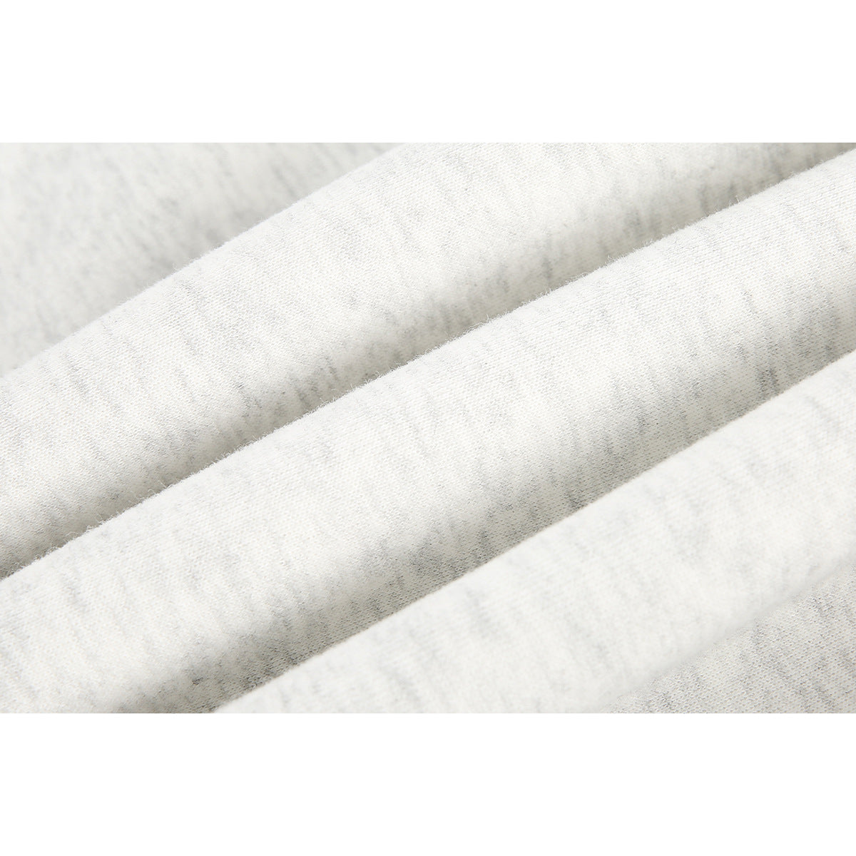 Extreme close-up of the light heather gray hoodie fabric, showing its knit texture and folds.