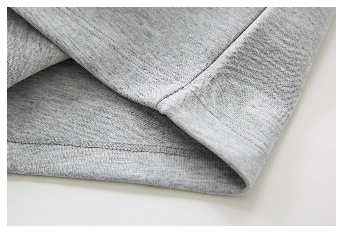 Close-up of the gray shorts’ hem and interior overlock stitching.