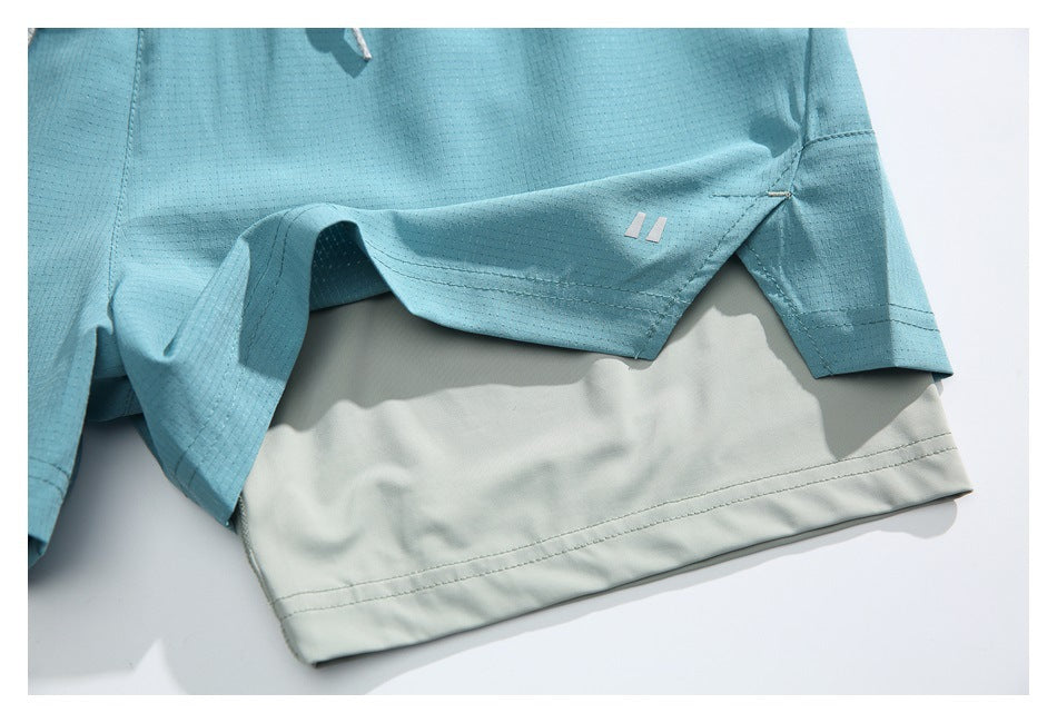 Close-up of an aqua shorts side slit, pale gray inner layer, and small two-bar mark.
