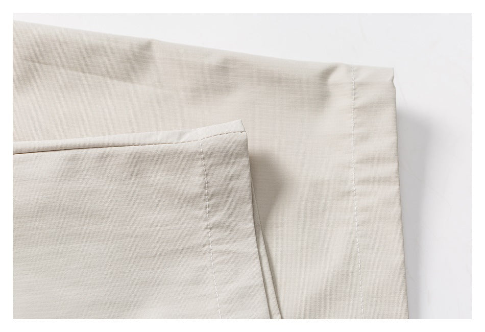 Close-up of a stitched edge and seam on light beige fabric.