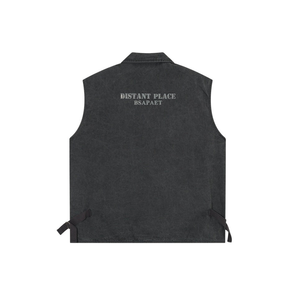 Back view of black washed sleeveless vest with a printed text graphic at the upper back and side buckle straps