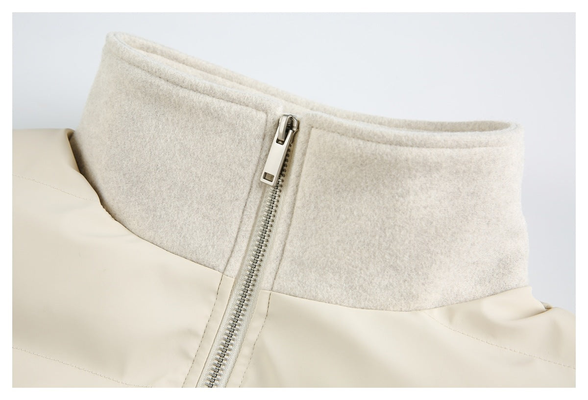 Close-up of the ivory jacket's stand collar and metal zipper.