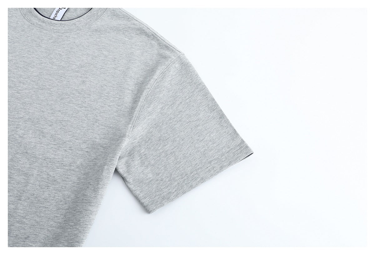 Close-up of the short sleeve and shoulder of a light gray T-shirt.