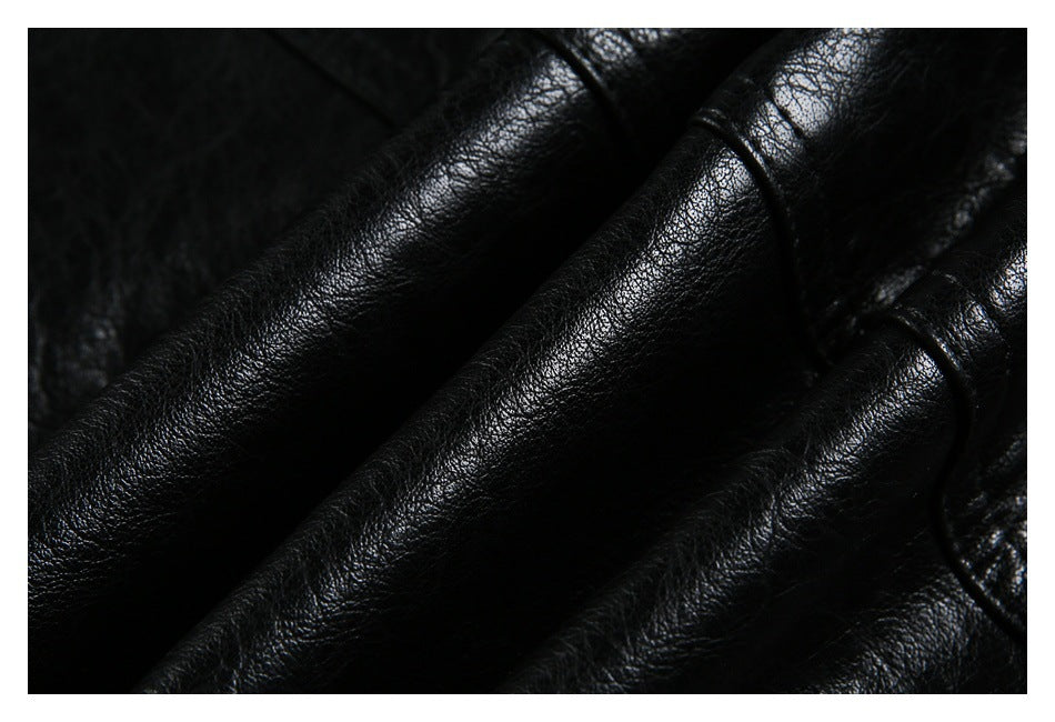 Macro view of the black jacket's glossy textured material and gathered folds.