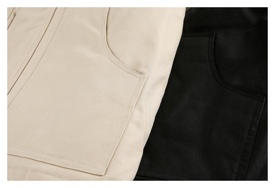 Close-up of large square patch pockets on beige and black garments.