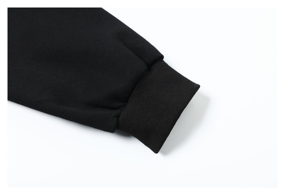 Close-up of a black sleeve ending in a wide ribbed cuff.