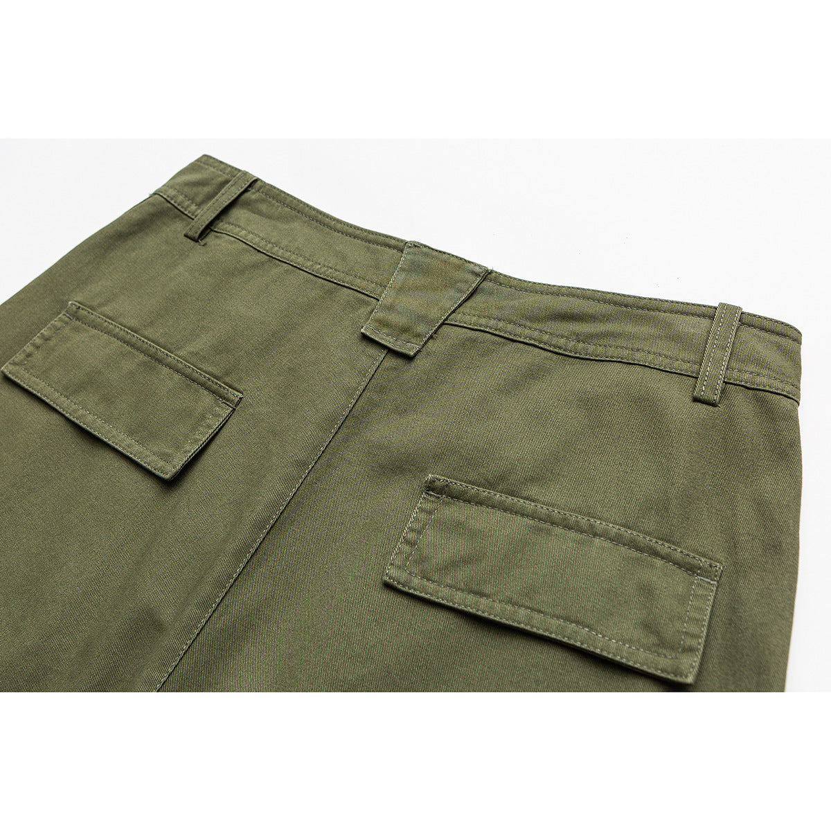Close-up of the back waist of olive-green pants with belt loops and two rectangular pockets.