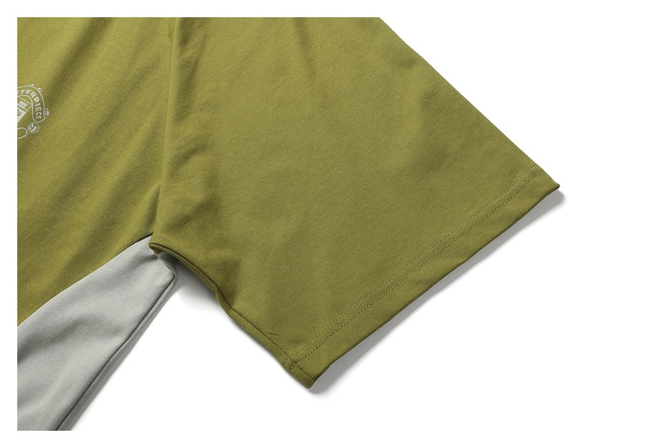 Close-up of an olive-green short sleeve and double-stitched hem, with part of a small chest emblem visible.