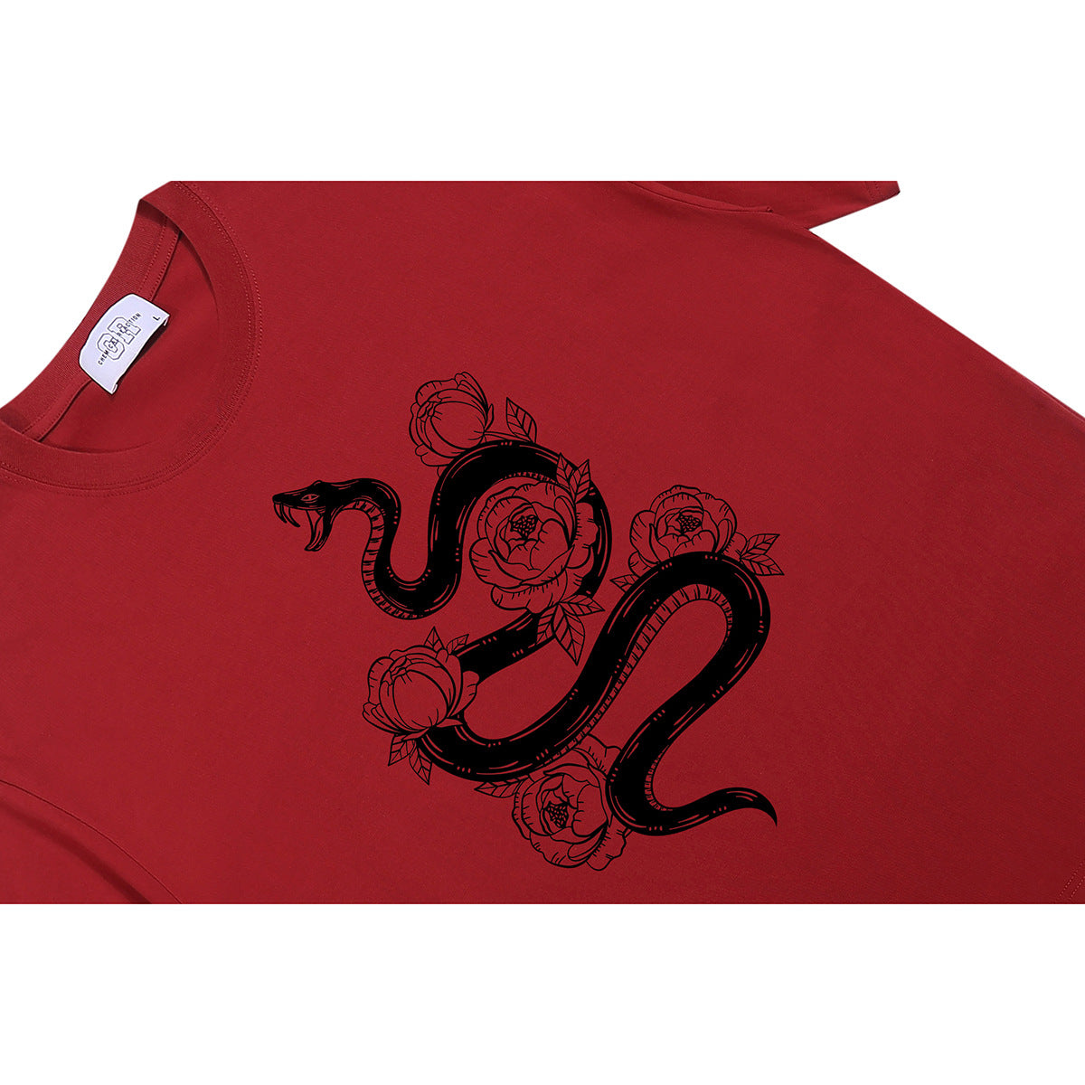Close-up of a red T-shirt with a black snake and flower graphic on the front.