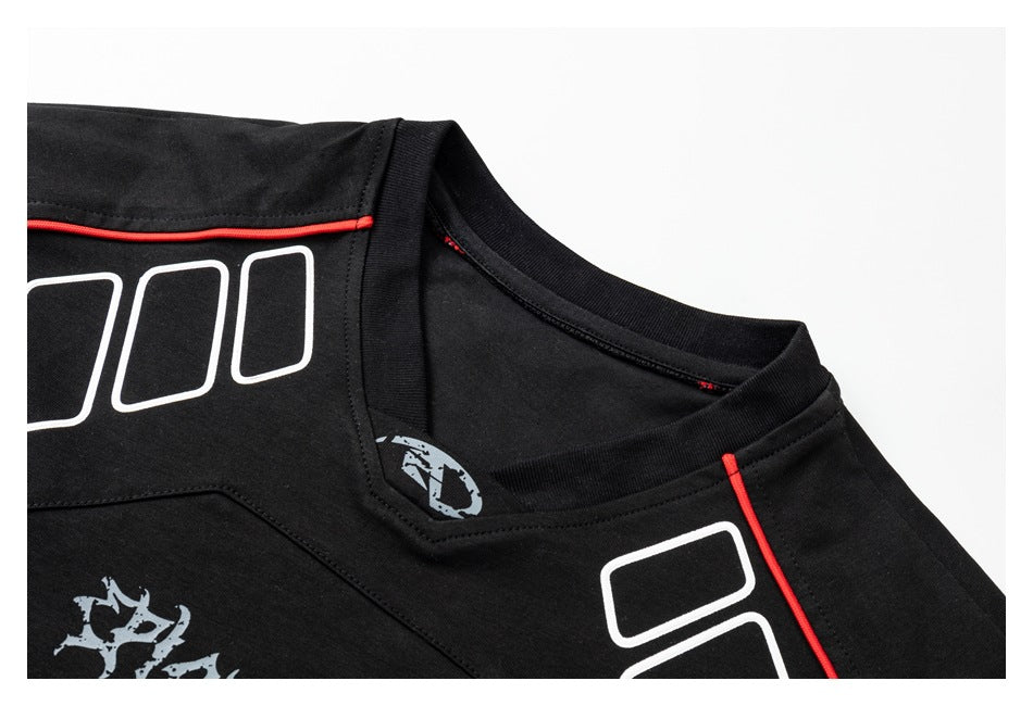 Close-up of a black shirt neckline with red piping and white and gray graphic prints.