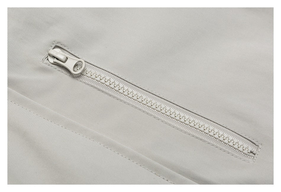 Close-up of a light gray zipper pocket with a chunky matching zipper.
