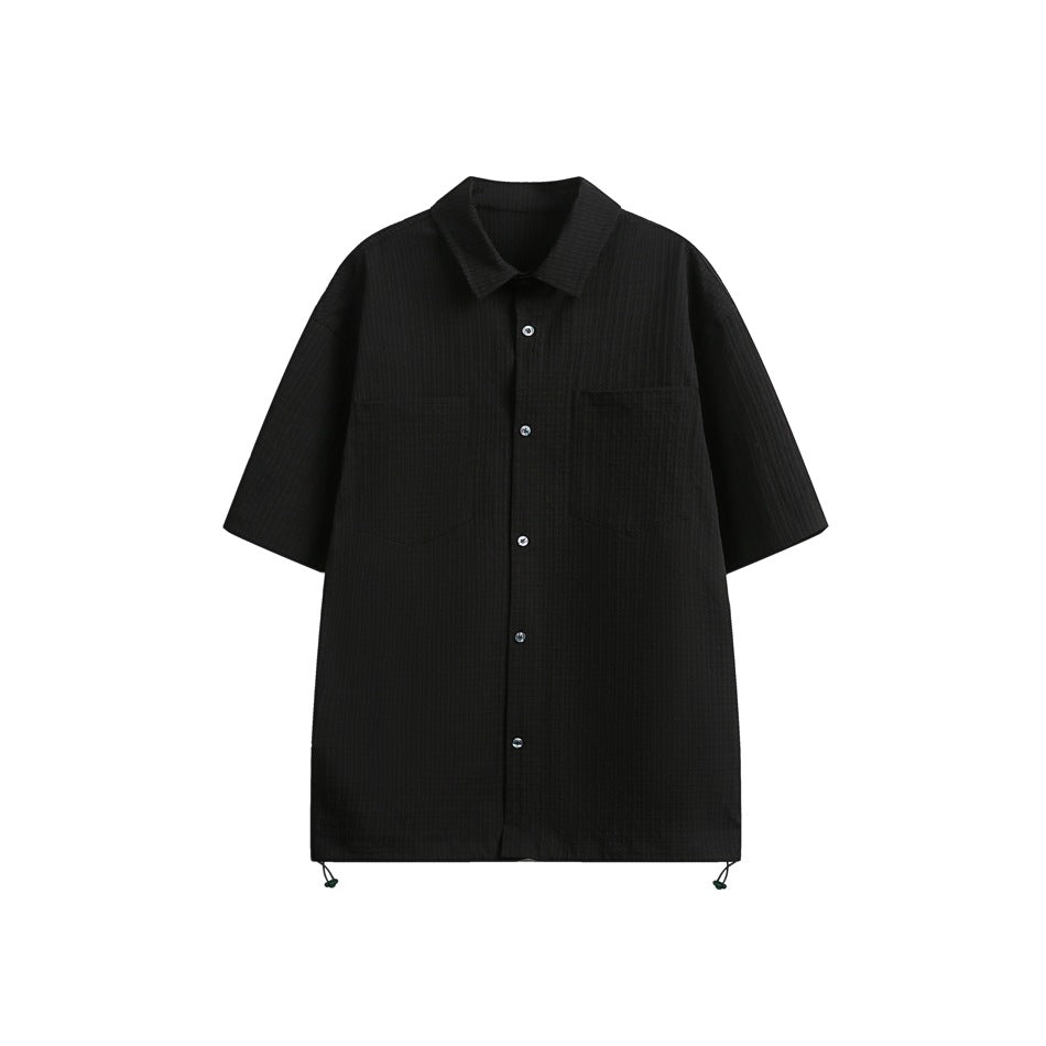 Black short-sleeve textured button-up shirt with two chest pockets and hem drawcord toggles, flat front view