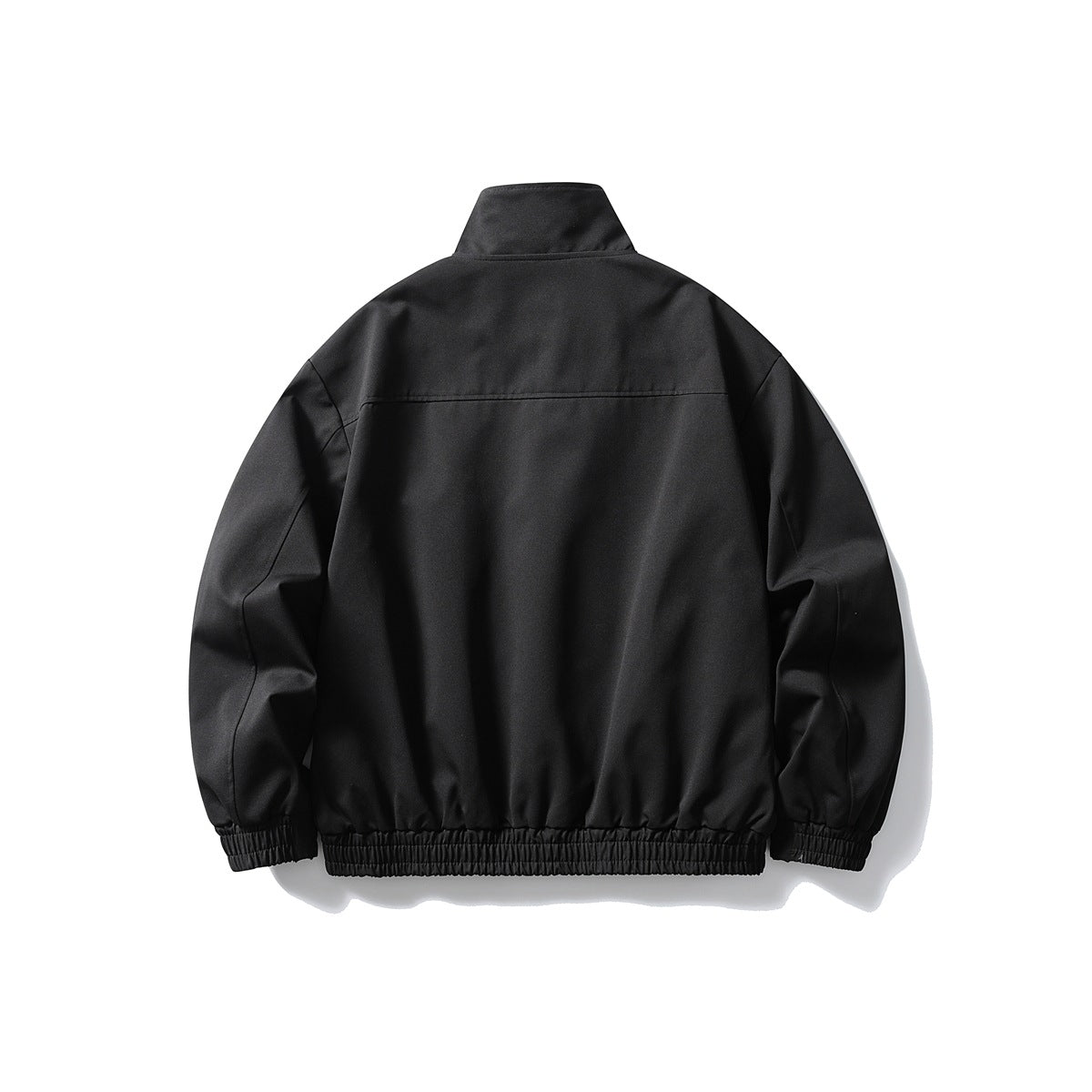 Back view of a black jacket with a high collar, long sleeves, and gathered elastic cuffs and hem.