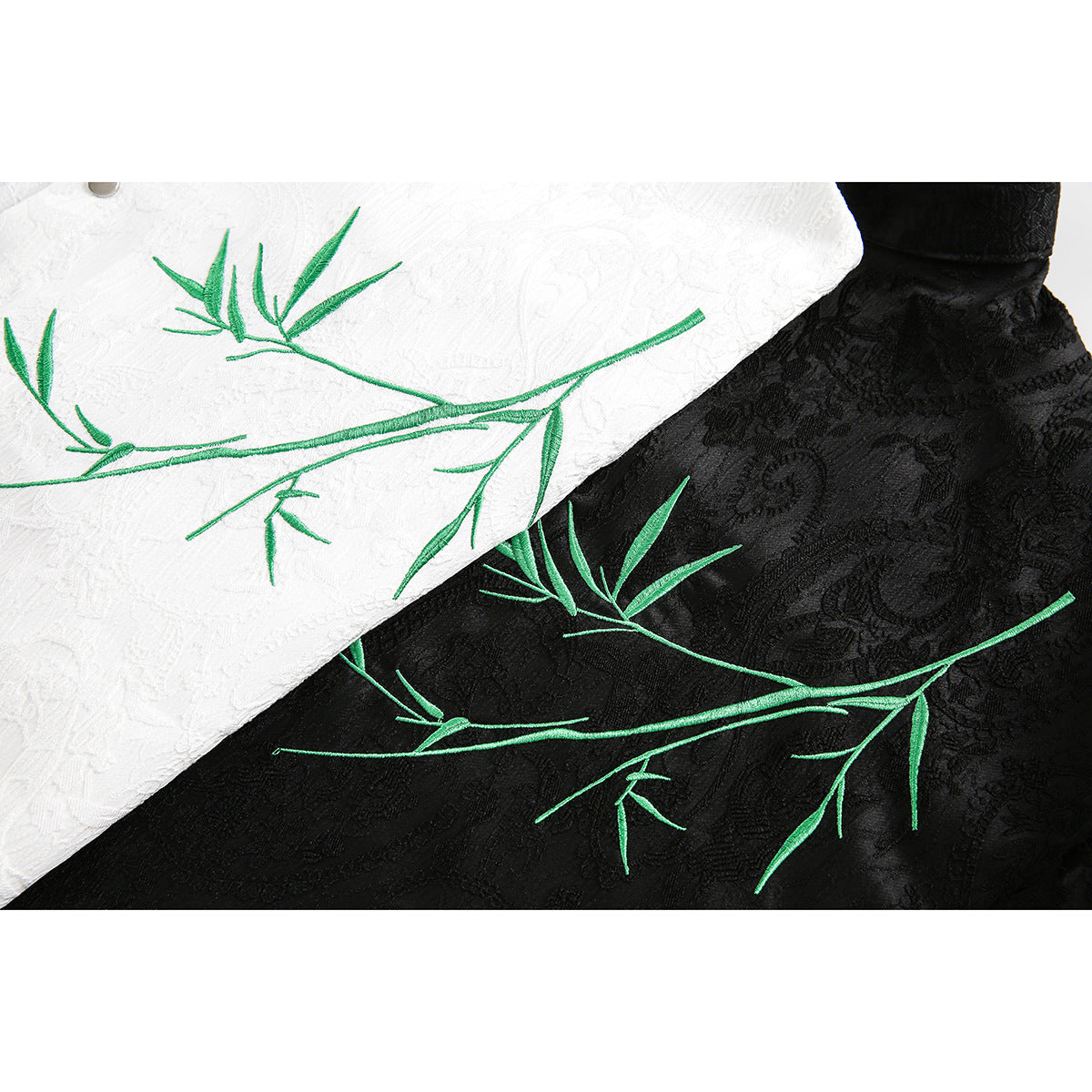 Green bamboo embroidery on white and black textured shirt fabric.