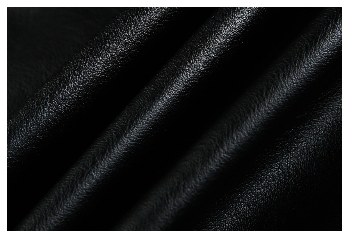 Close-up of black pebbled material draped in soft folds.