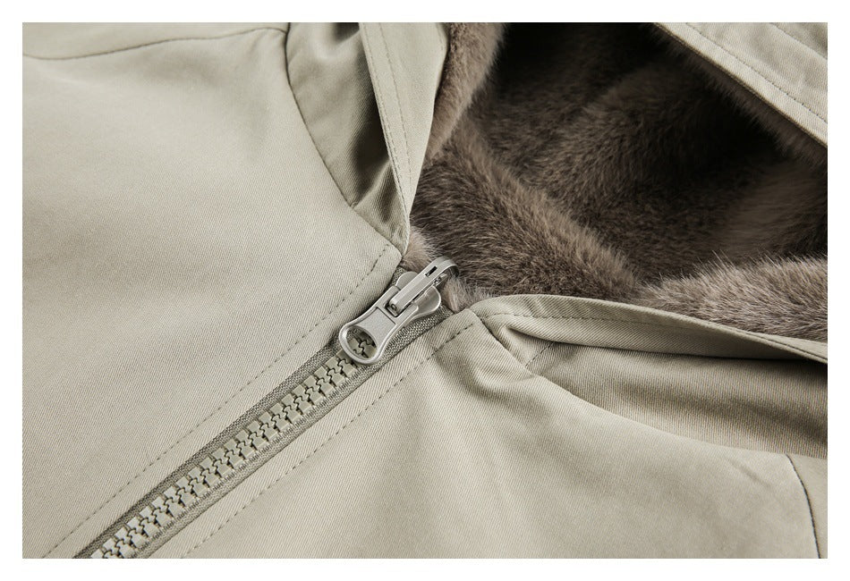 Close-up of the beige jacket zipper, stitching, and brown plush lining.