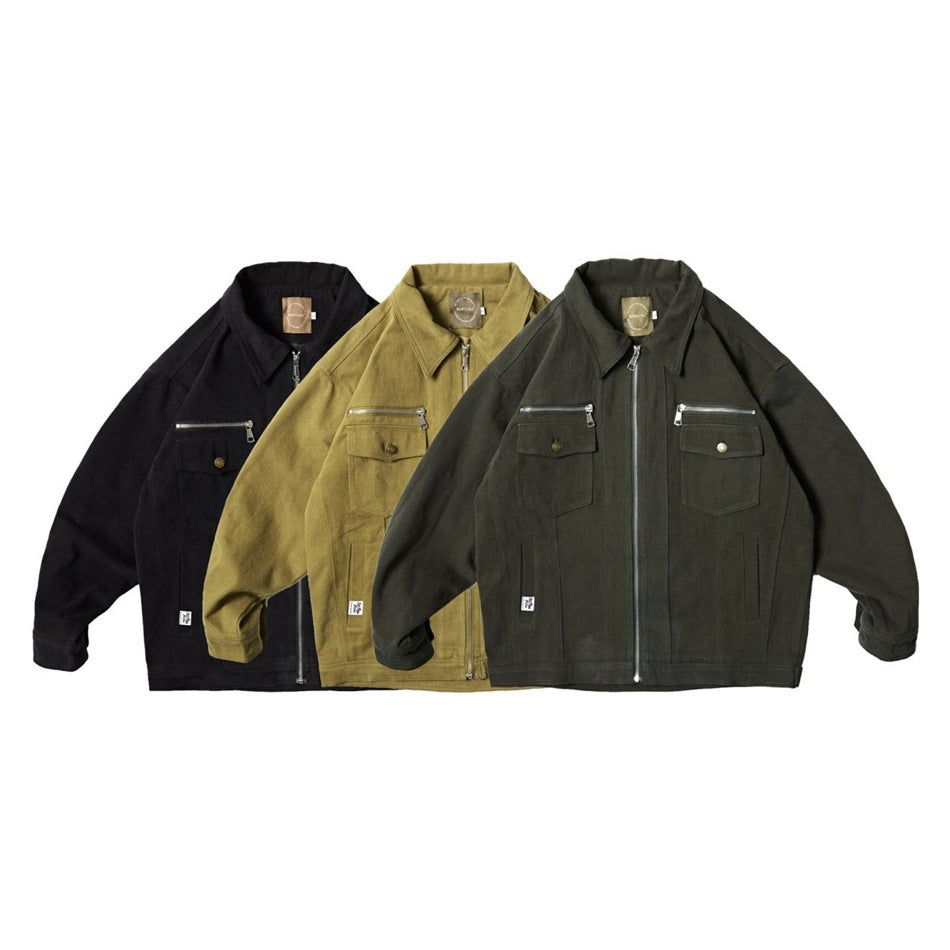 Three work jackets shown from the front in black, mustard, and dark olive, with zip fronts and chest pockets.