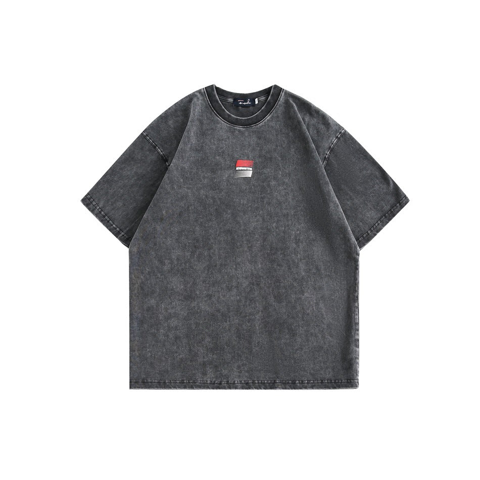 Front of washed charcoal black short-sleeve crew-neck T-shirt with small red and white chest graphic