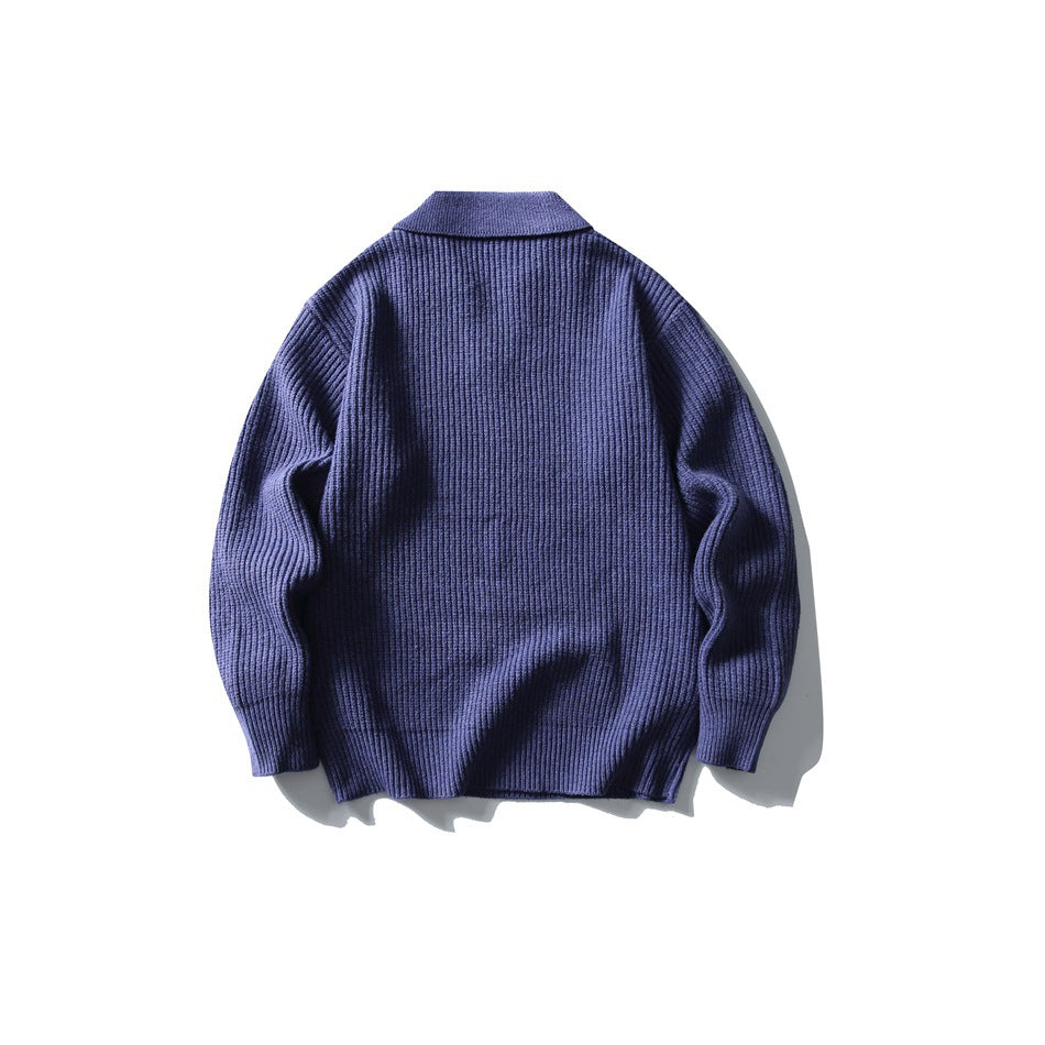 Back view of a blue ribbed knit polo sweater laid flat on a white background.