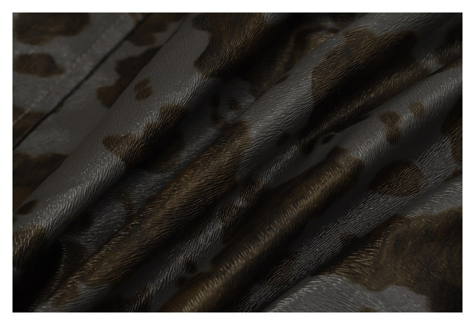 Close-up of draped gray, brown, and black animal-print fabric with a rippled texture.