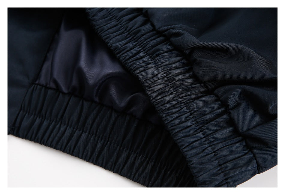 Close-up of a gathered elastic waistband and dark lining on a navy garment.