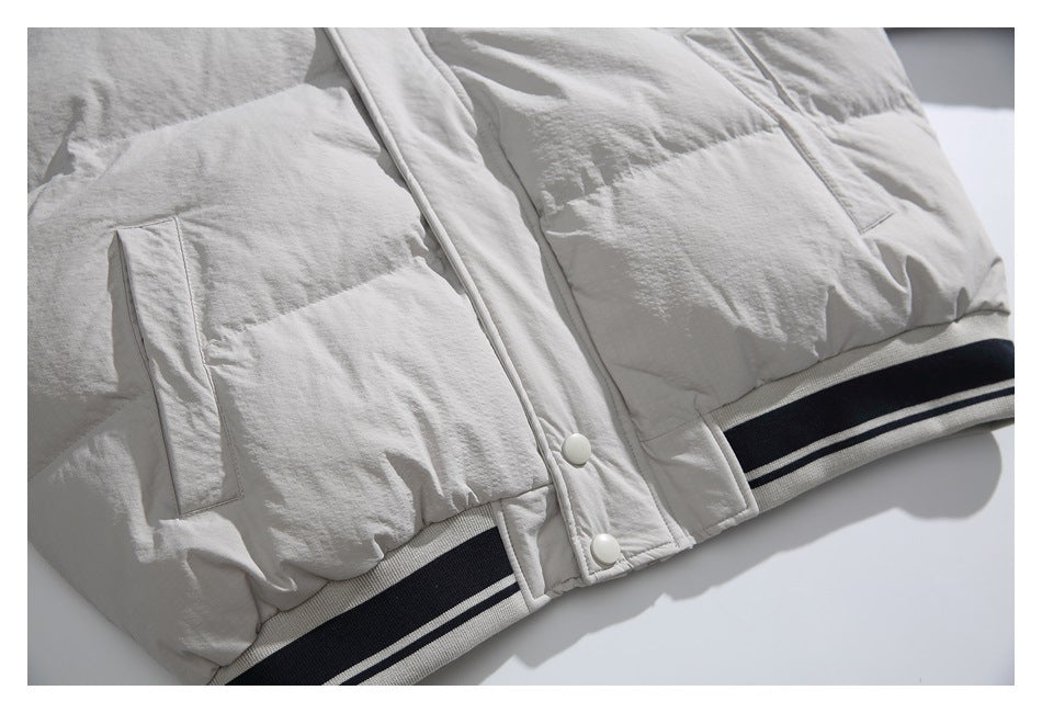 Cropped view of a light jacket with flap pockets, snap-front placket and striped ribbed hem.