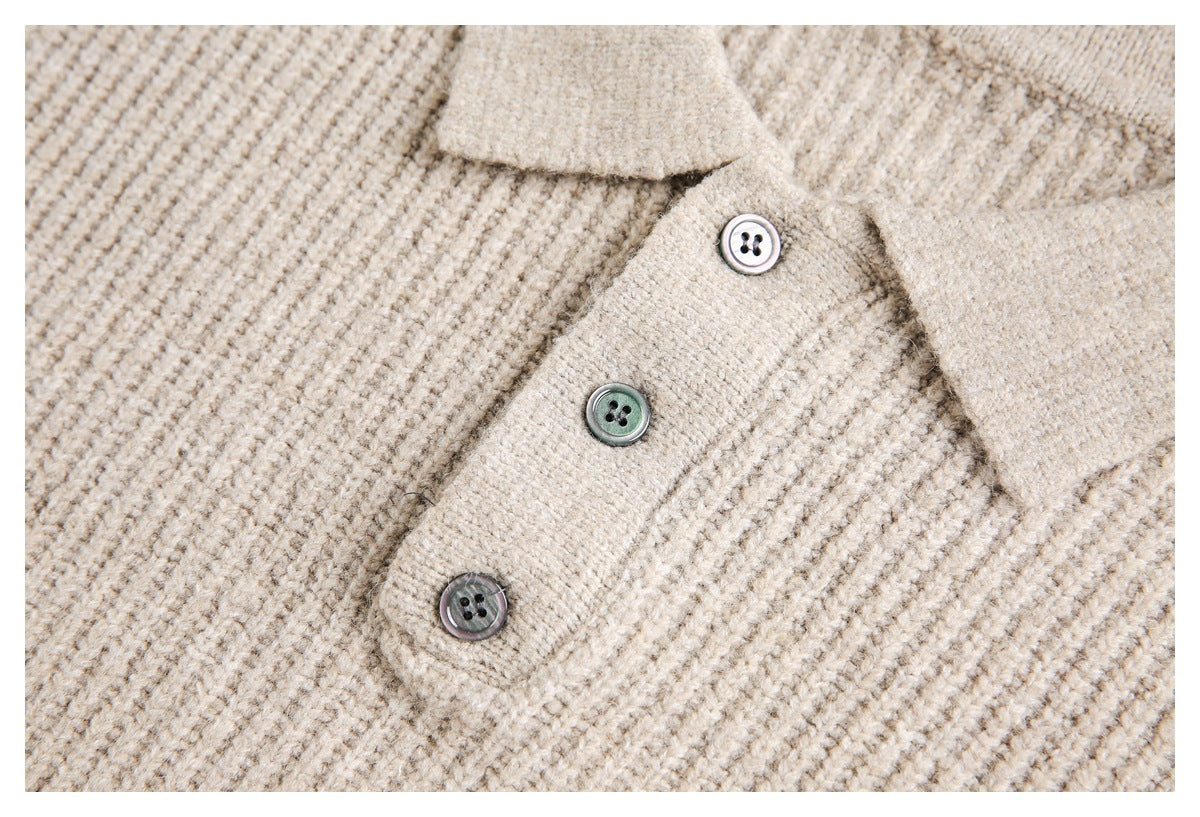Close-up of three contrasting buttons on the placket of a beige textured knit top.