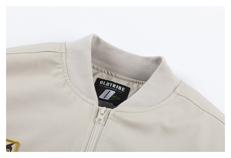 Close-up of the light beige jacket's ribbed collar, zipper, and sewn-in brand label.