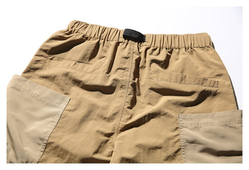Back view of tan shorts with an elastic waist, black webbing loop, and two rear pockets.