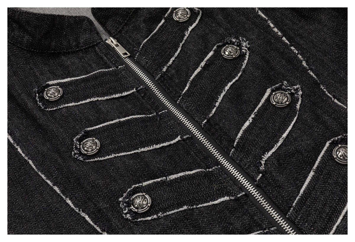 Close-up of a black denim garment with a diagonal metal zipper, decorative buttoned tabs, and frayed pale edging.