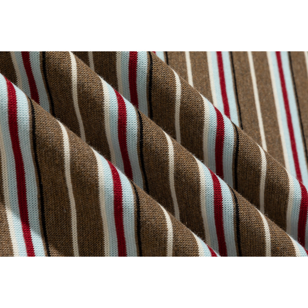 Macro view of brown knit fabric with red, pale blue, and white stripes.