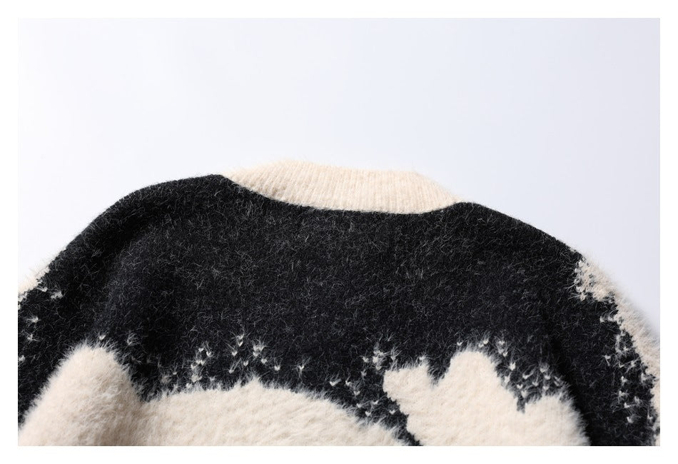 Close-up of the sweater's back neckline and shoulders, with an ivory collar and black-and-ivory knit pattern.