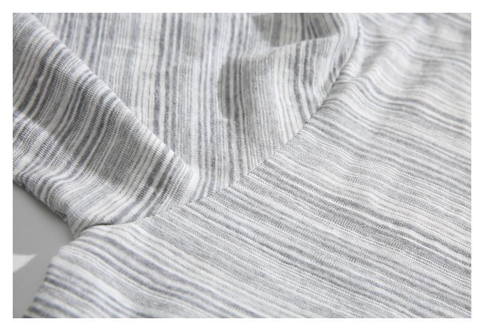 Close-up of the gray-and-white striped fabric and stitching around the underarm seam.