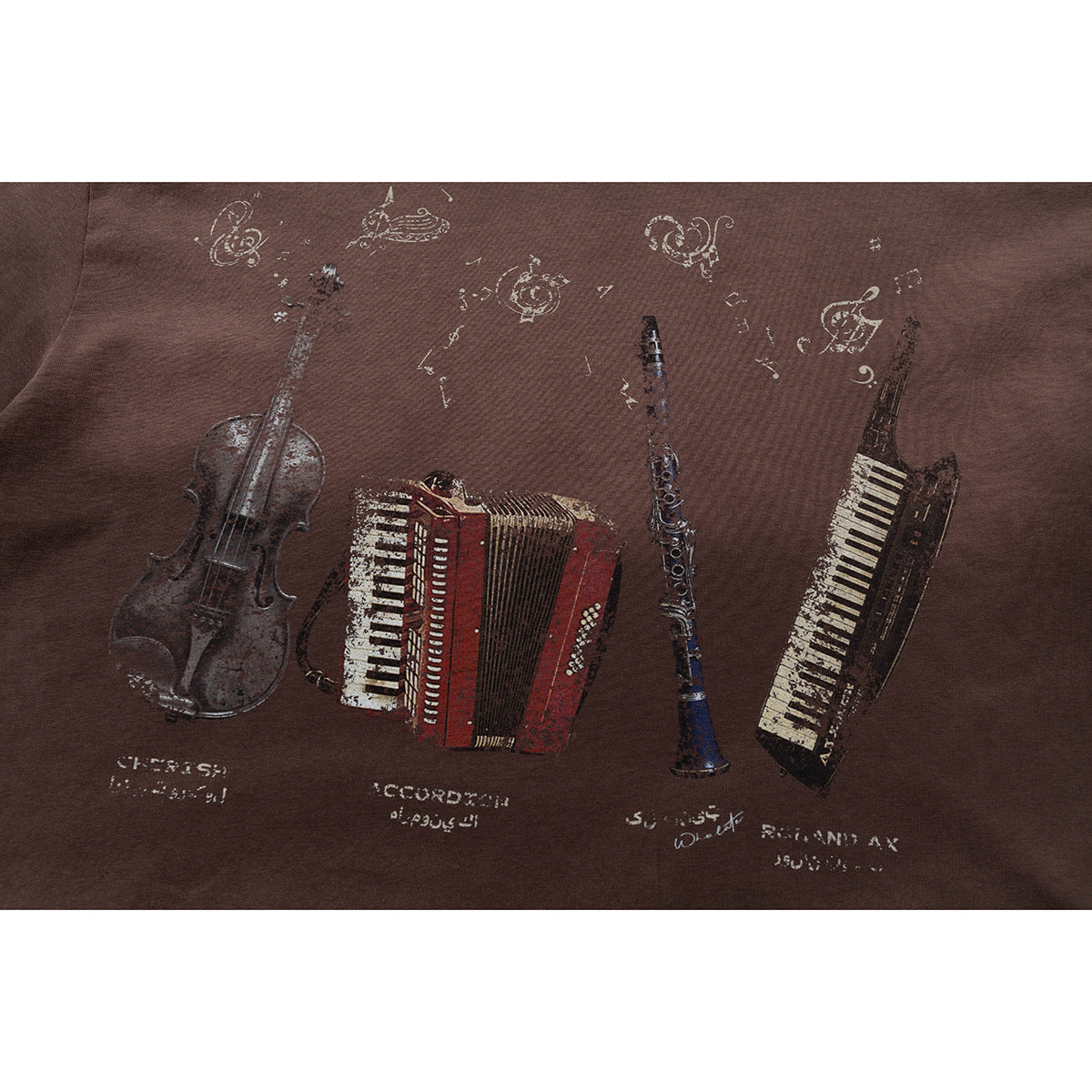 Close-up of a dark brown T-shirt's distressed musical-instrument graphic.