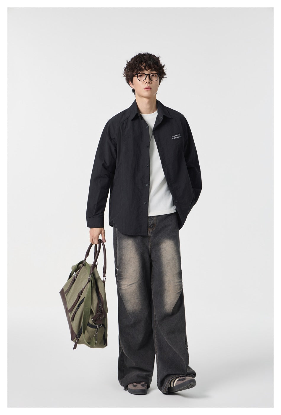 Full-length model wearing a black button-front overshirt, white tee, and wide-leg washed jeans.