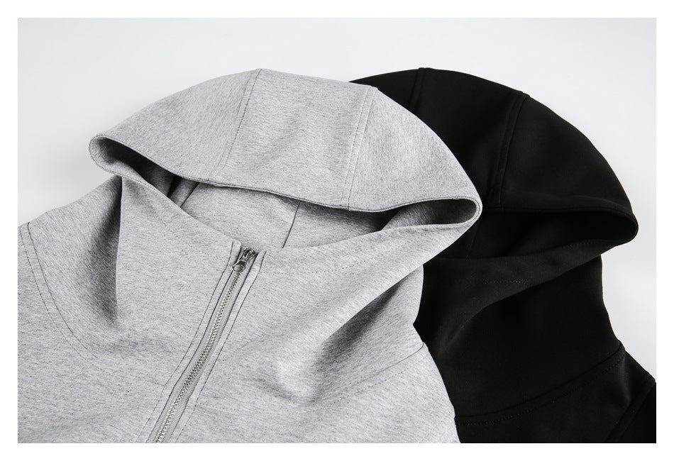 Close-up of light gray and black hoodies showing the hoods and silver front zipper on the gray one.