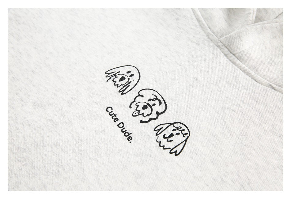 Close-up of a light heather gray hoodie with cartoon faces and “Cute Dude.” printed on the chest.