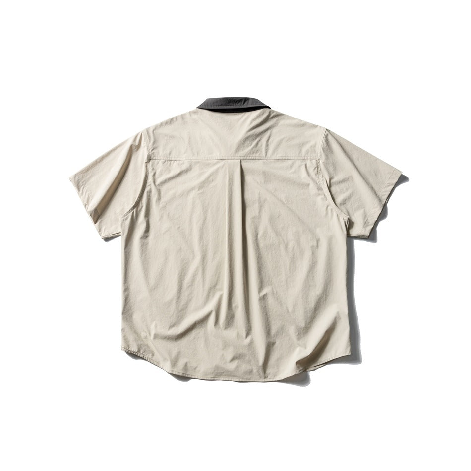Beige short-sleeve shirt back view with dark gray collar, back yoke seam and center pleat, flat lay