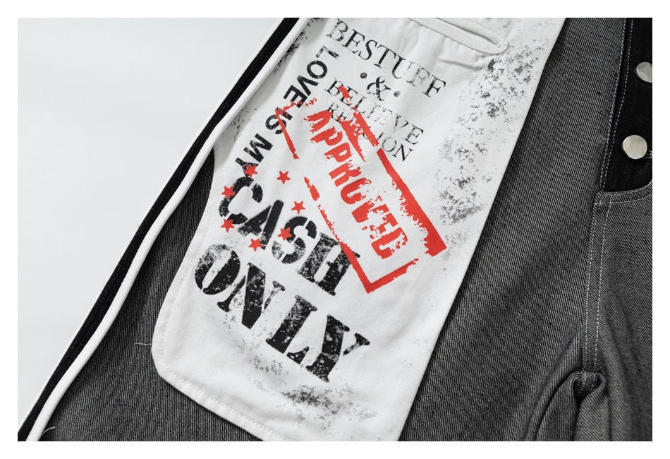 Close-up of gray trousers with a white panel featuring distressed black lettering and a red stamp graphic.