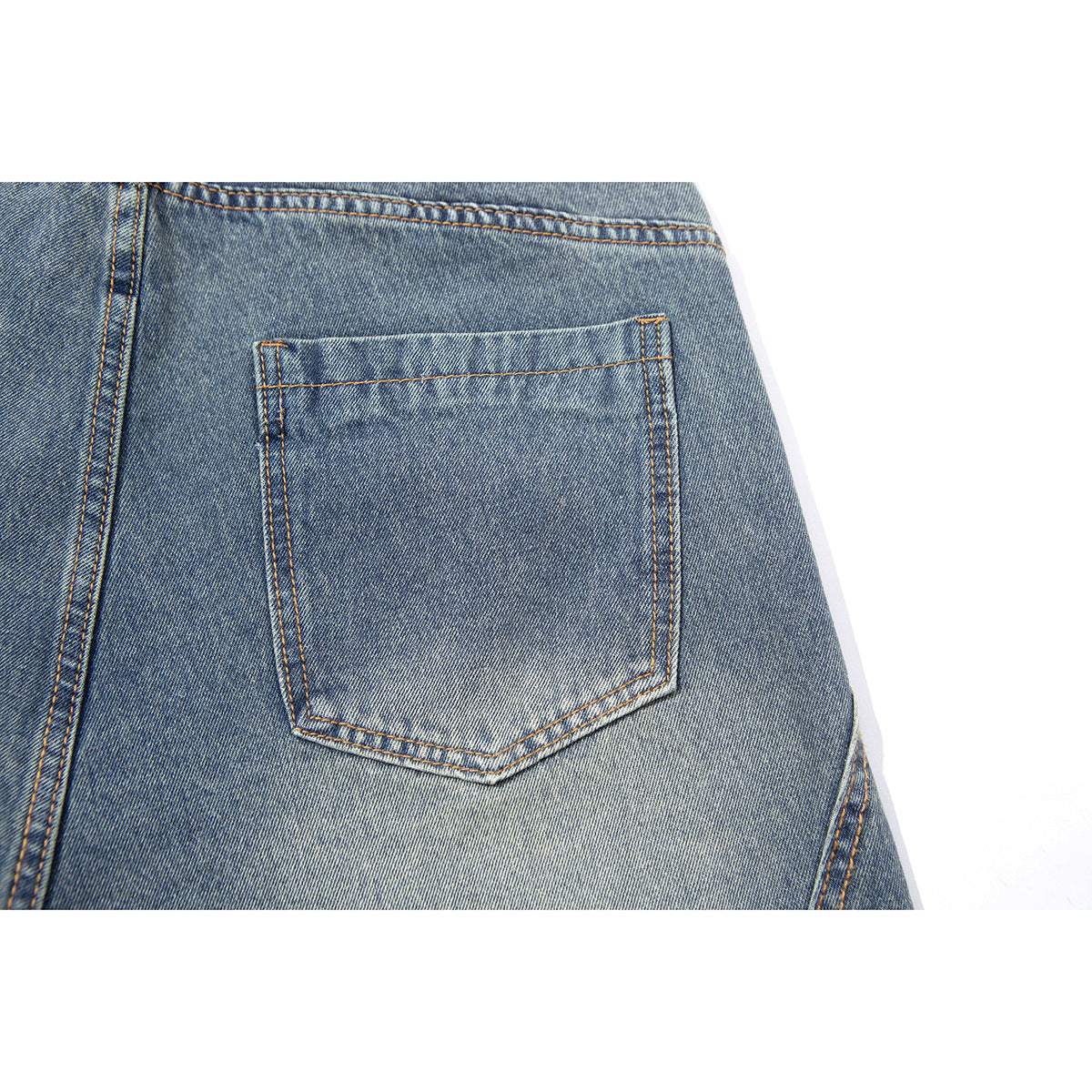 Close-up of the back of blue denim pants, centered on a stitched patch pocket.