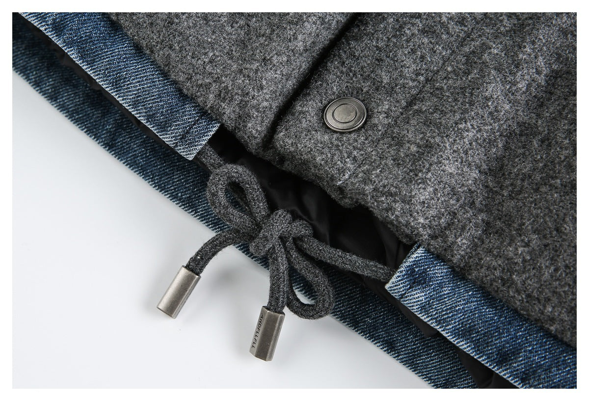 Close-up of charcoal gray garment with blue edging, a metal snap, and a drawstring with metal tips.