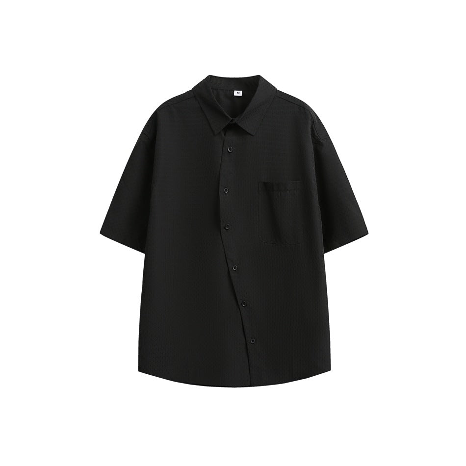 Black short-sleeve shirt with a textured fabric, diagonal button front and chest pocket, flat lay on white