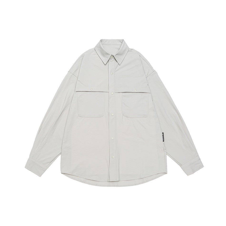 Beige long-sleeve button-up shirt with two large chest pockets, flat lay front view