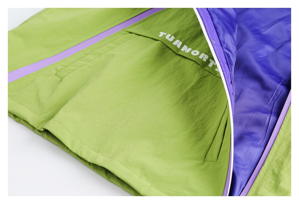 Open lime-green jacket pocket showing purple lining, white lettering, and lavender zipper trim.