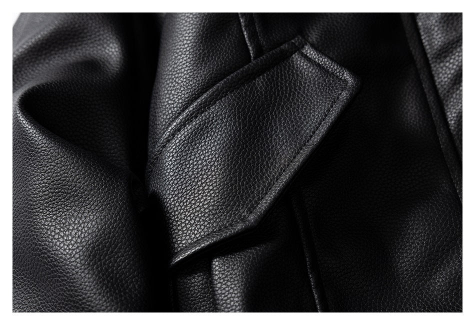 Close-up of a black pebbled jacket lapel and overlapping seams.