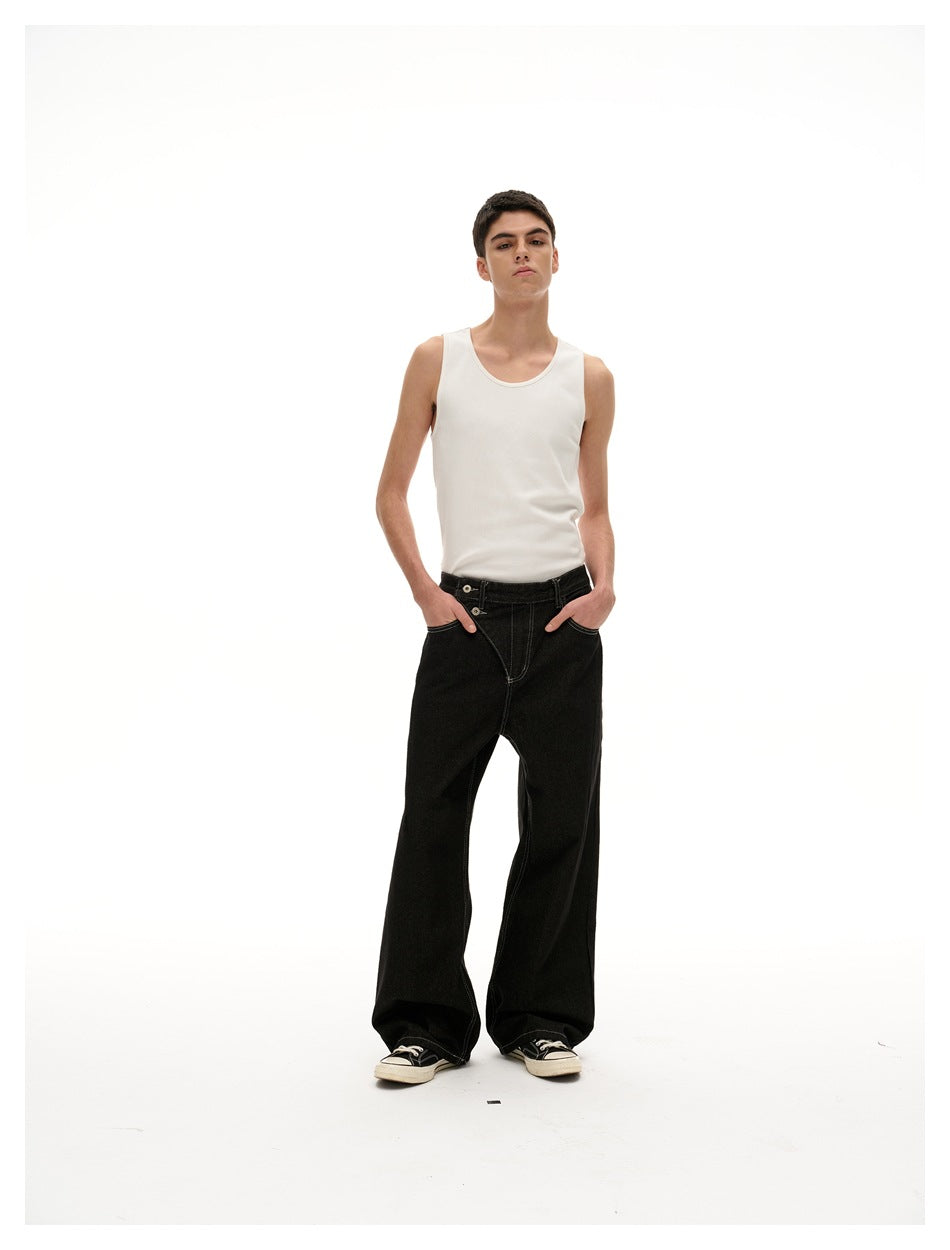 Front full-body view of a model in a white tank top and loose black jeans against a white background.