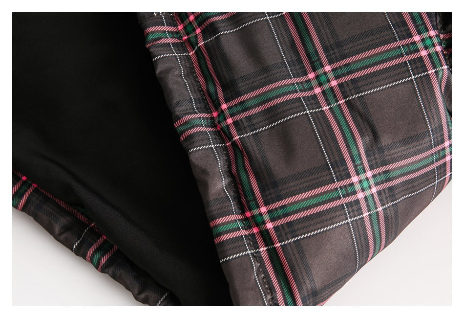 Close-up showing the jacket's dark inner lining beside its plaid outer fabric.