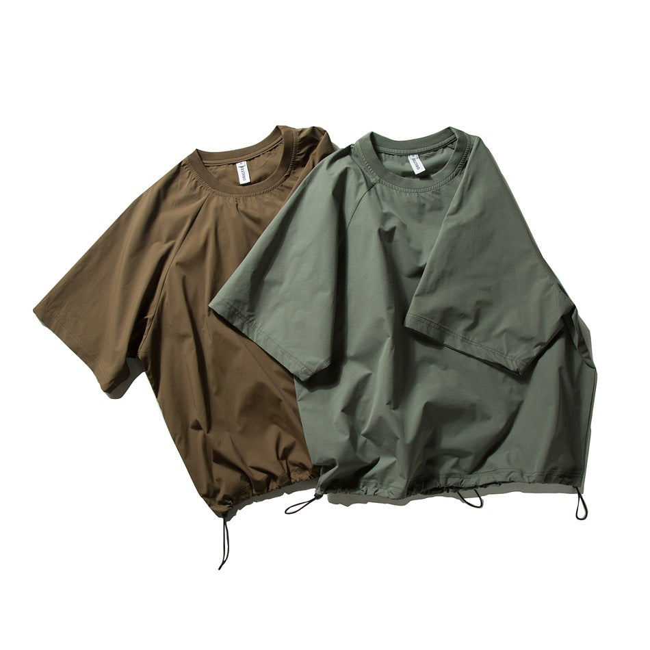 Two short-sleeve crew-neck tops, one brown and one muted green, with adjustable drawcord hems.