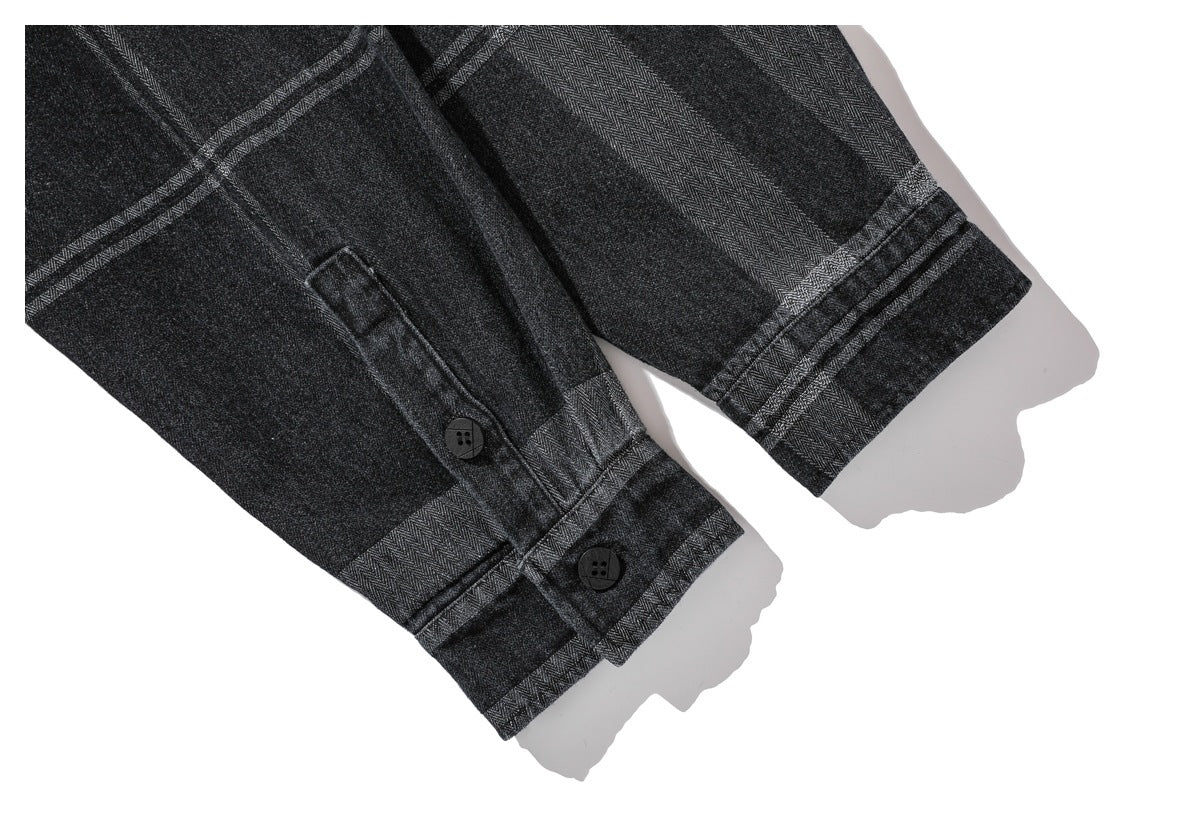 Close-up of the charcoal plaid shirt's buttoned cuff and sleeve hem.
